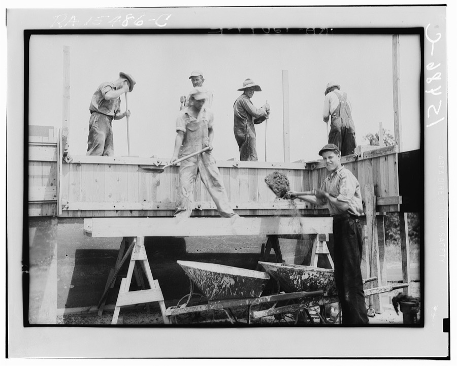 Rammed earth construction near Birmingham, Alabama. After each three-inch layer has been tamped, another layer is spread in the form and work resumed