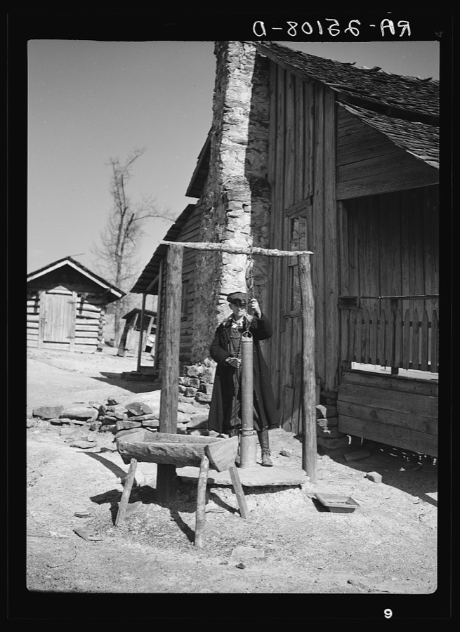 Tenant farmer at well. Walker County, Alabama