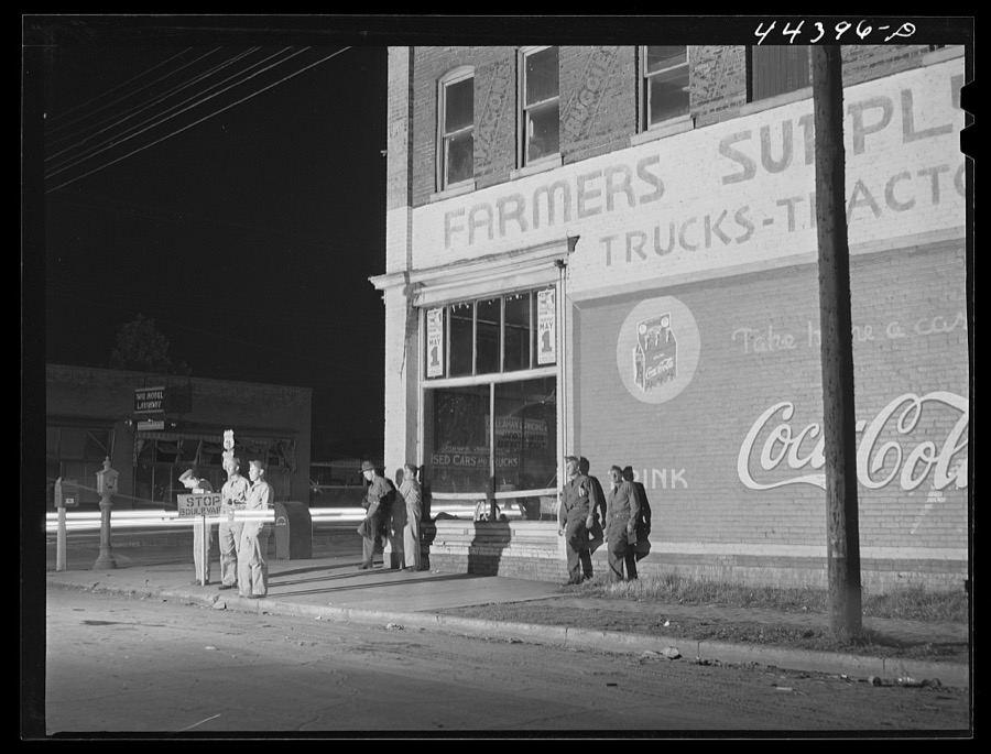Soldiers from a nearby Army camp waiting for a bus in Anniston, Alabama