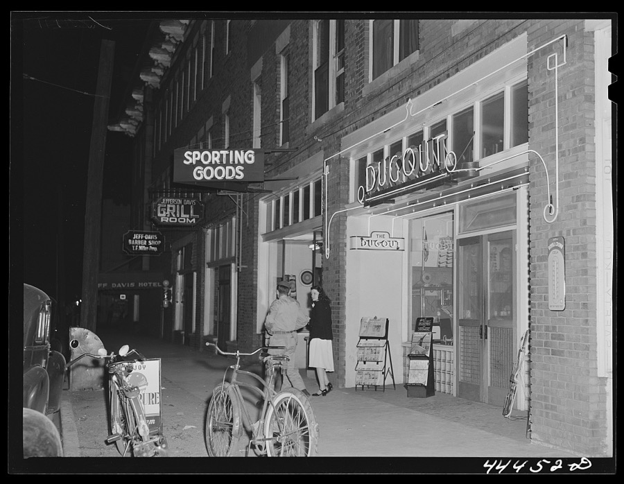 Soldier and his girl coming out of a restaurant in Anniston, Alabama