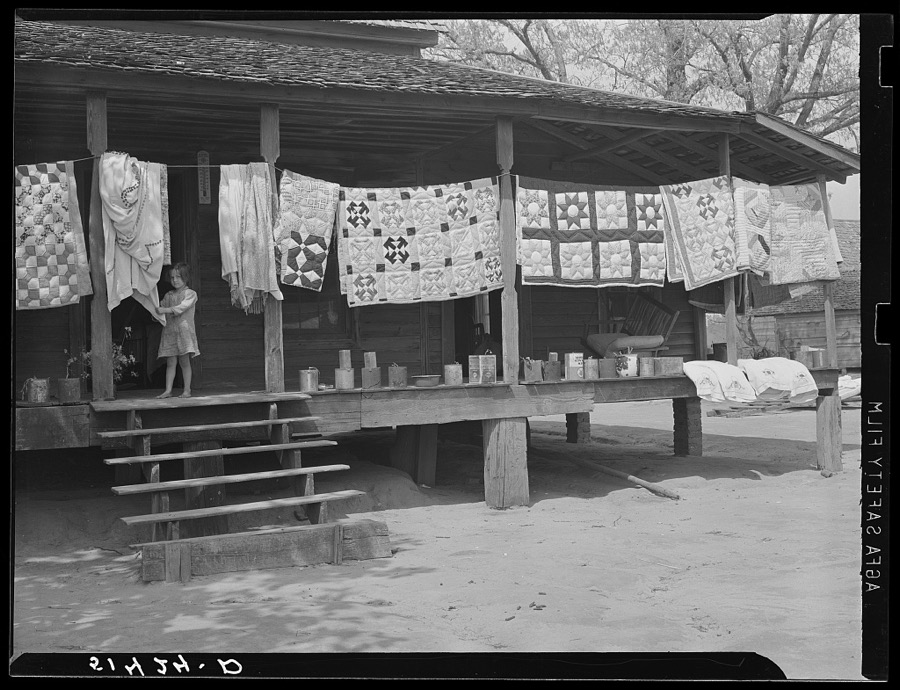 Typical farmhouse, spring housecleaning, homemade quilts and bedding in sun. Coffee County, Alabama