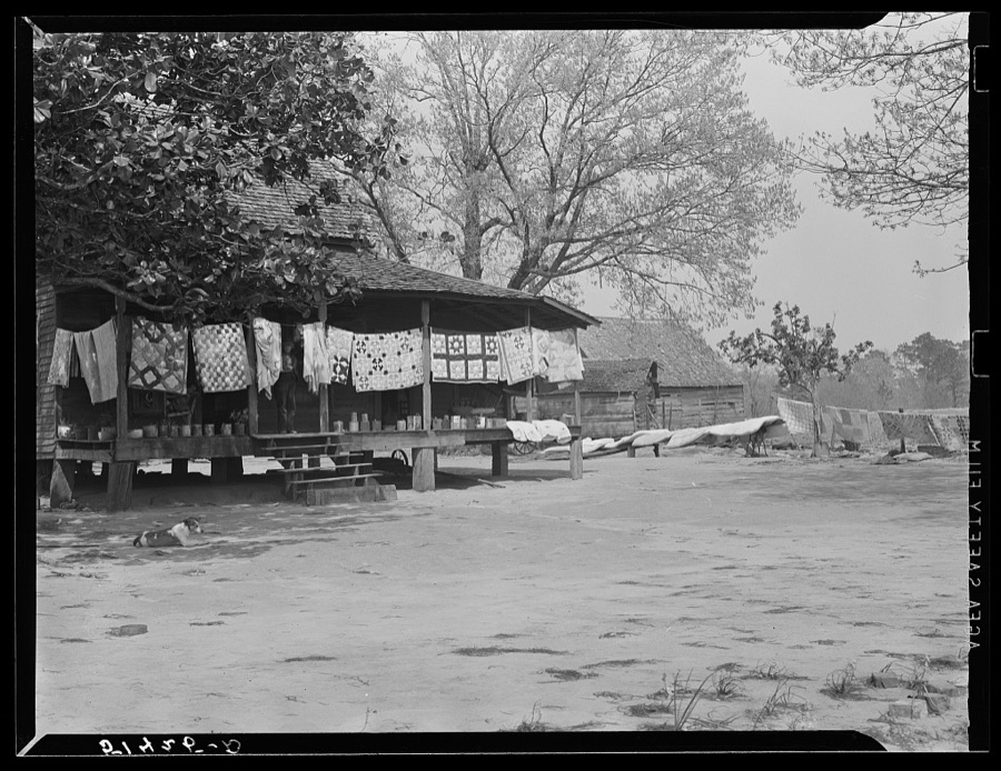 Typical farmhouse, spring housecleaning, homemade quilts and bedding in sun. Coffee County, Alabama