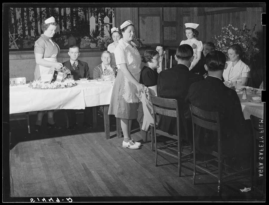 In the auditorium of the Mount Zion School, the Chamber of Commerce of a nearby town is being served dinner by home economics class. Coffee County, Alabama