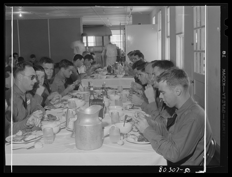 "Like real home-cooked chicken" say these Craig Field flying cadets, in praise of the tender FSA (Farm Security Administration) "Food for Defense" chickens. Craig Field, Southeastern Air Training Center, Selma, Alabama