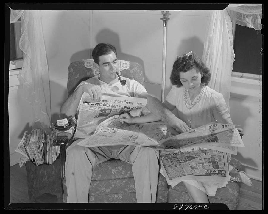 Childersburg, Alabama. Cousa Court defense housing project. Mr. Smith and his wife, both defense workers in the Dupont powder plant, follow the course of the war through the local paper