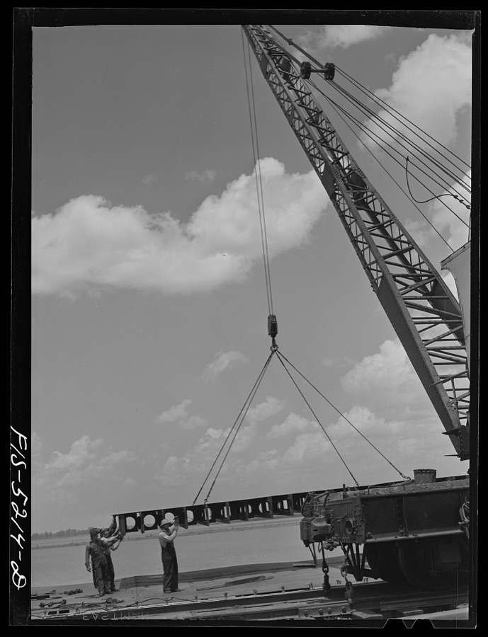 Decatur, Alabama. Ingalls Shipbuilding Company. A section of a ship's bottom being lowered into place