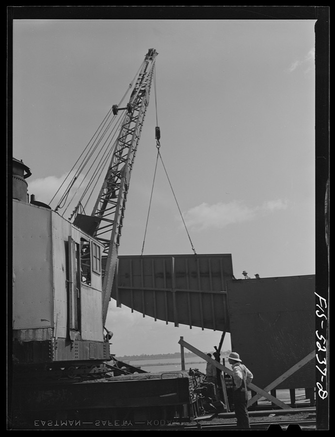 Decatur, Alabama. Ingalls Shipbuilding Company. Lowering into place one of the sides of the stern of a barge under construction