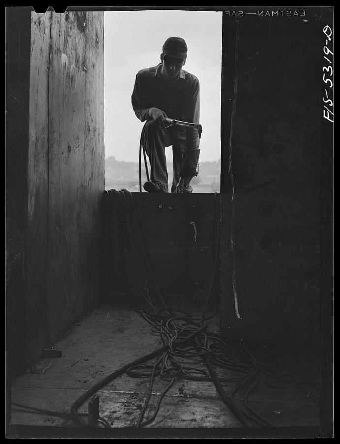 Dacetur, Alabama. Ingalls Shipbuilding Company. A young tacker working on one of the barges