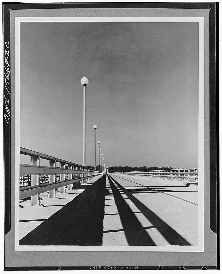 Wheeler Dam and powerhouse. Roadway on top of Wheeler Dam, part of public highway. Note open steel rail composed of car building rolled shapes strong enough to act as guardrails for heaviest vehicles