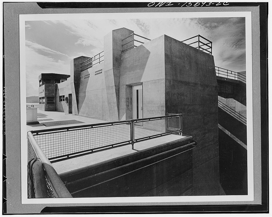 Guntersville Dam and powerhouse. End of spillway deck at navigation lock. Heavy concrete pilings serve as bumpers for gantry deck cranes. Wing houses lock operating machinery and control room