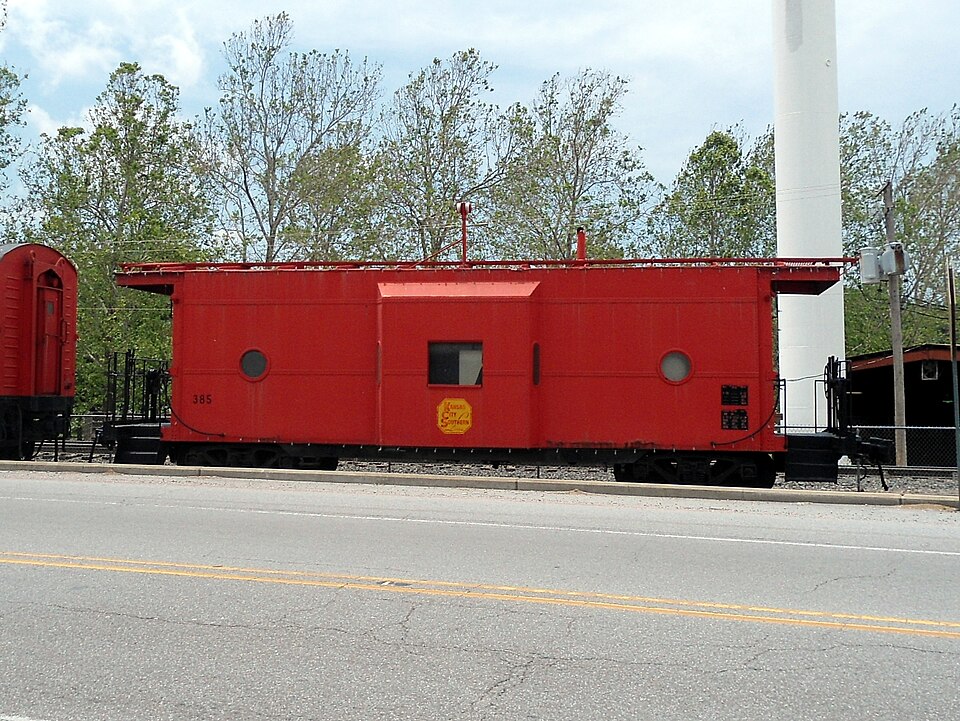 Photograph of Kansas City Southern Railway Locomotive No. 73D and Caboose No. 385