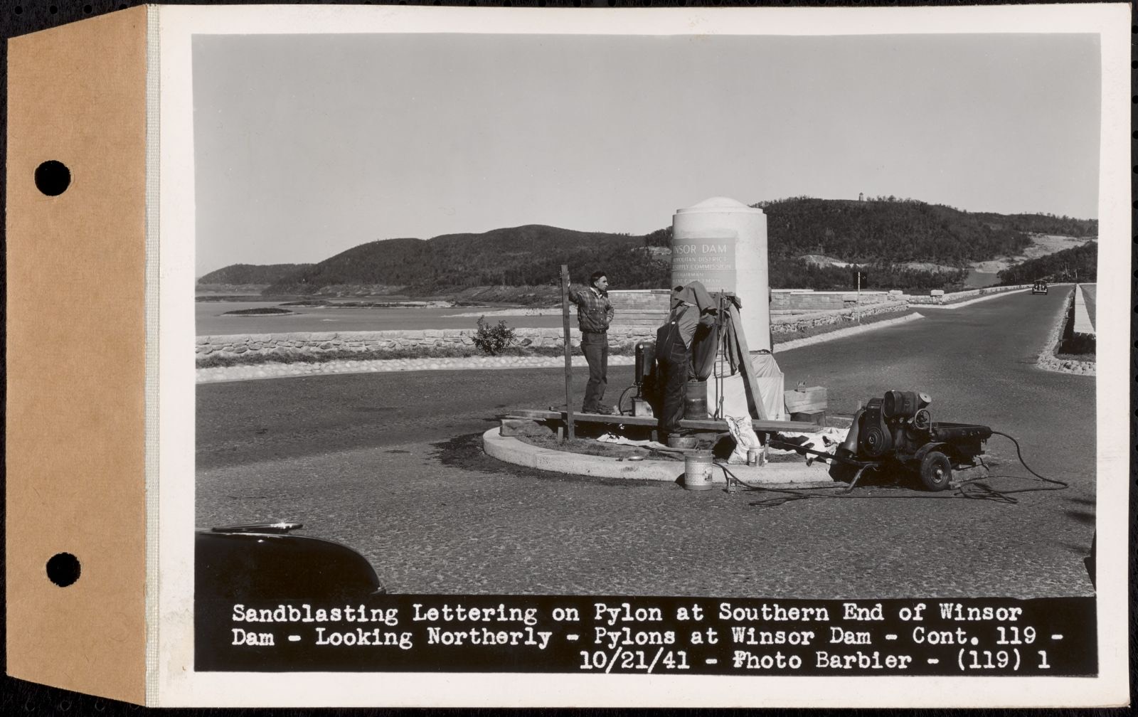 Contract No. 119, Furnishing and Setting Two Granite Pylons, Belchertown, Ware, sandblasting lettering on pylon at southern end of Winsor Dam, looking northerly, Quabbin Reservoir, Belchertown and Ware, Mass., Oct. 21, 1941, Massachusetts Archives - undated