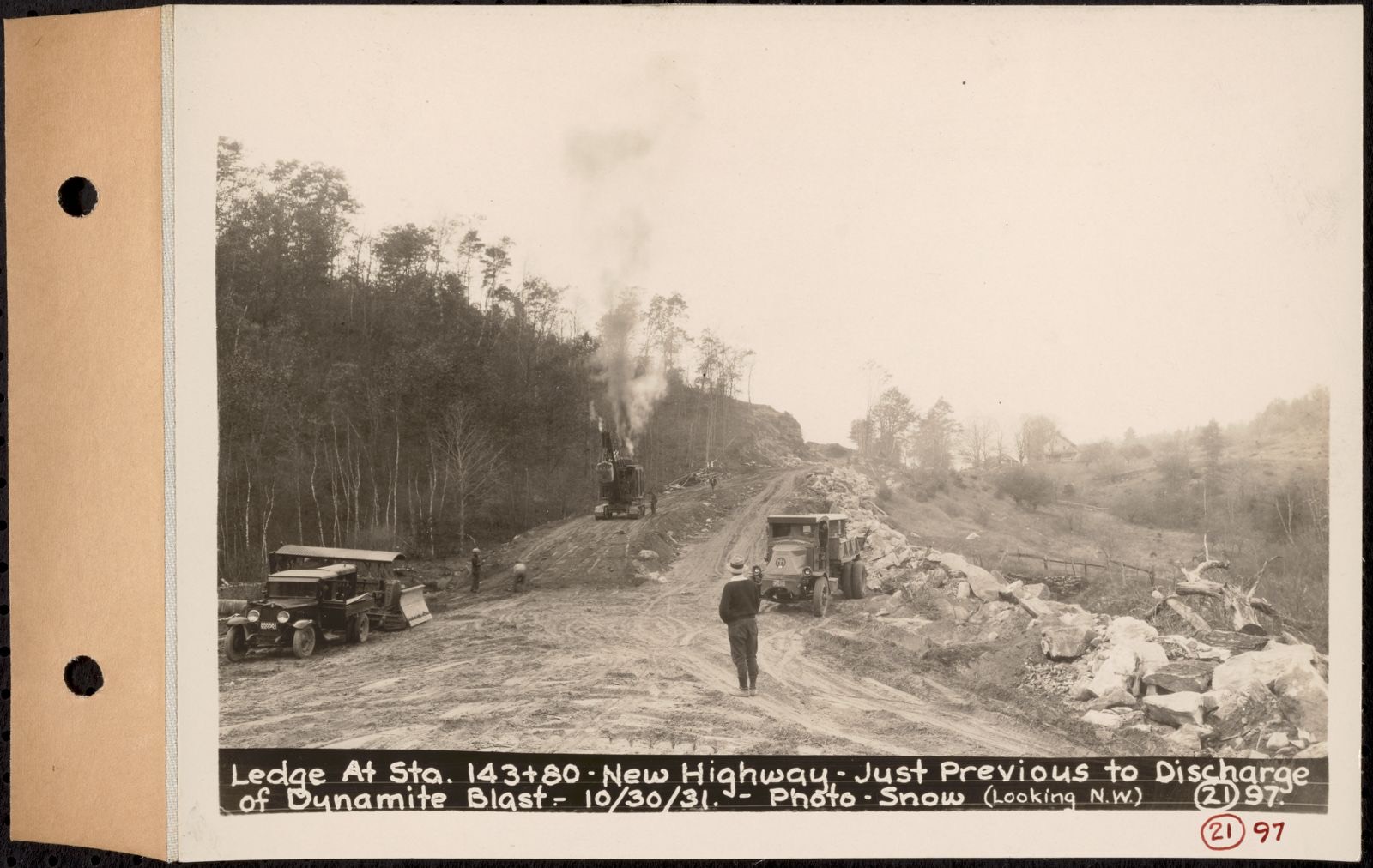 Contract No. 21, Portion of Ware-Belchertown Highway, Ware and Belchertown, ledge at sta. 143+80, new highway, just previous to discharge of dynamite blast, Ware and Belchertown, Mass., Oct. 30, 1931, Massachusetts Archives - undated