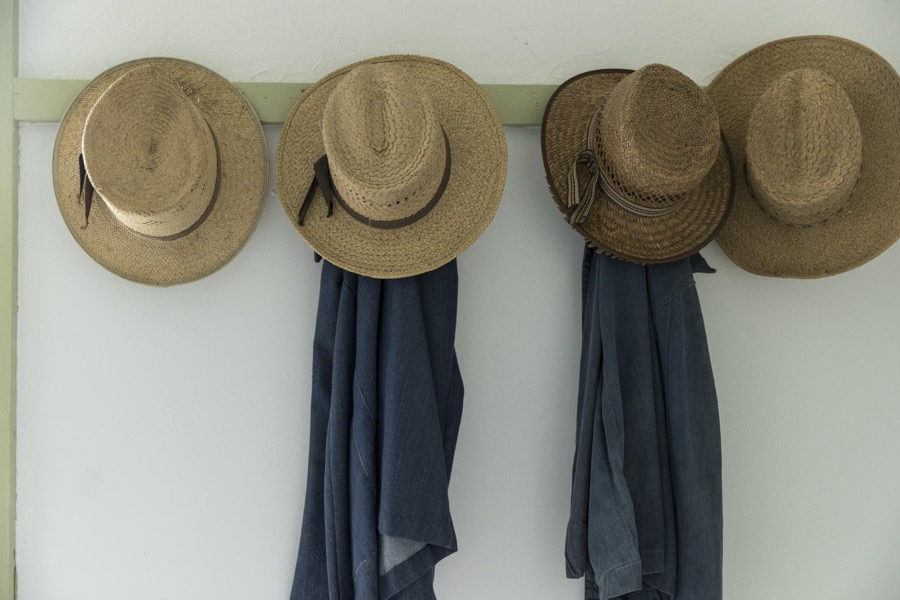 Men's straw hats, hanging inside the farmhouse at Yoder's Amish Home, an authentic Amish farm that began accepting visitors in 1983 near Walnut Creek in central Ohio, along the "Amish Country Byway"