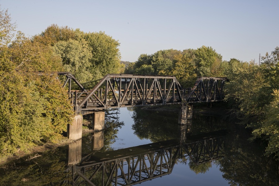 Old railroad bridge over the Mahoning River in Mahoning County, Ohio, amidst a stretch of abandoned mills that once bustled with activity before the decline of northern Ohio's steel industry
