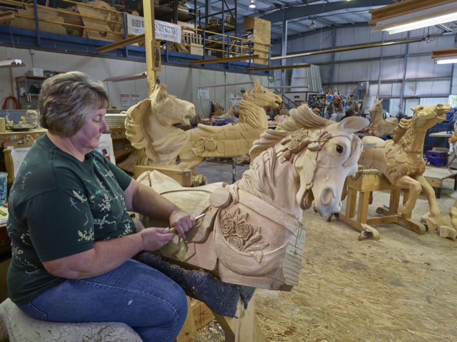 In Mansfield, Ohio, artisan Donna Grantham chisels a detail on a wooden horse at the Carousel Works, the world's largest maker of carousels, sometimes called "merry-go-rounds"