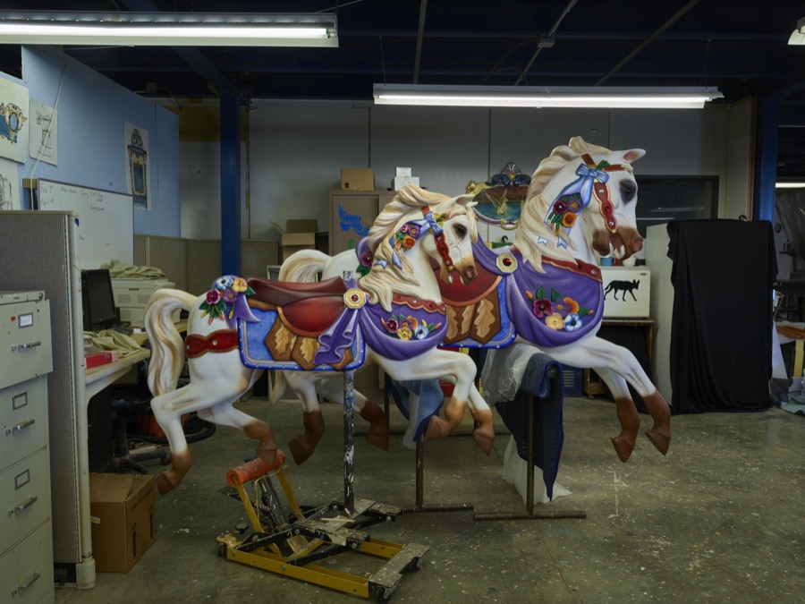 In Mansfield, Ohio, beautiful "show ponies" of the carnival kind await shipment at the Carousel Works, the world's largest maker of carousels, sometimes called "merry-go-rounds"