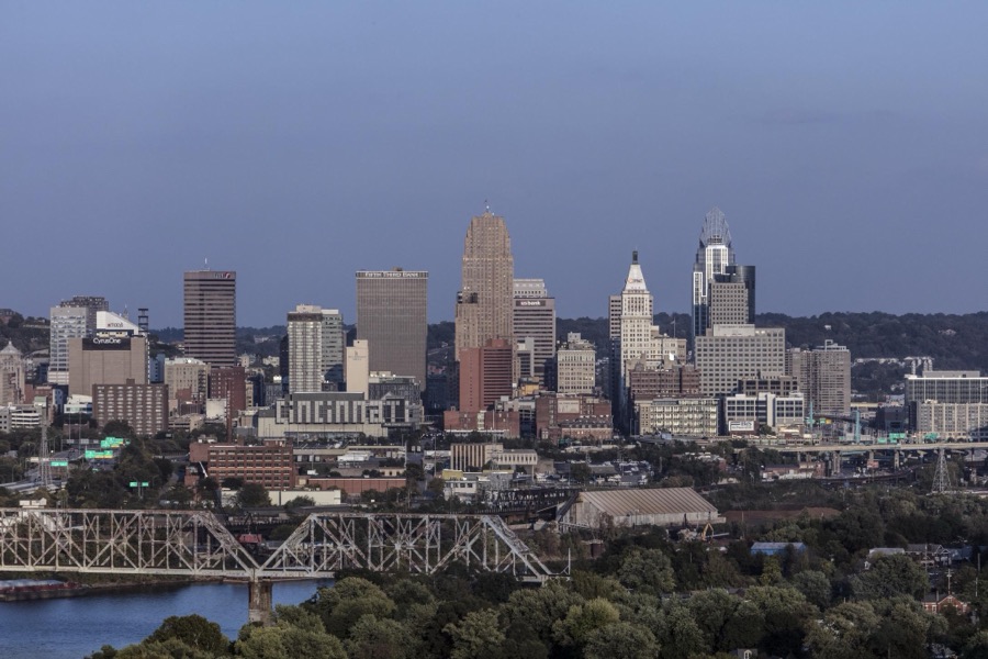 Dusk view of the Cincinnati, Ohio skyline, including a look at the giant, illuminated "CINCINNATI" sign on the city's convention center, Duke Energy Center