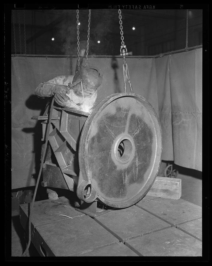 Making the sparks fly. The welding machine glows brightly as a worker in an eastern arsenal attacks a fabricated structure for the 90 mm gun anti-aircraft carriage