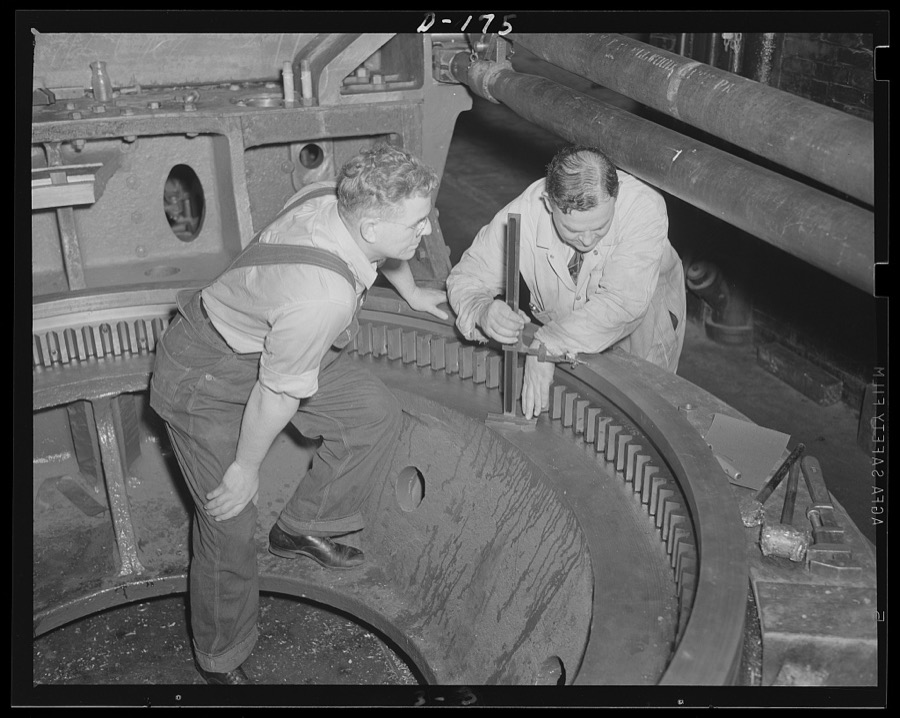Firm understanding. The big base ring for an 8-inch gun, railway carriage, is inspected in an eastern arsenal