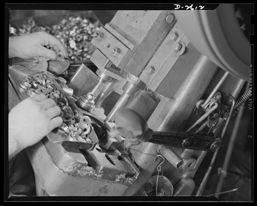 Conversion. Toy factory. Closeup of press in production of condenser caps to which it has been converted. Former production of this machine consisted of toys and movie projectors. Keystone