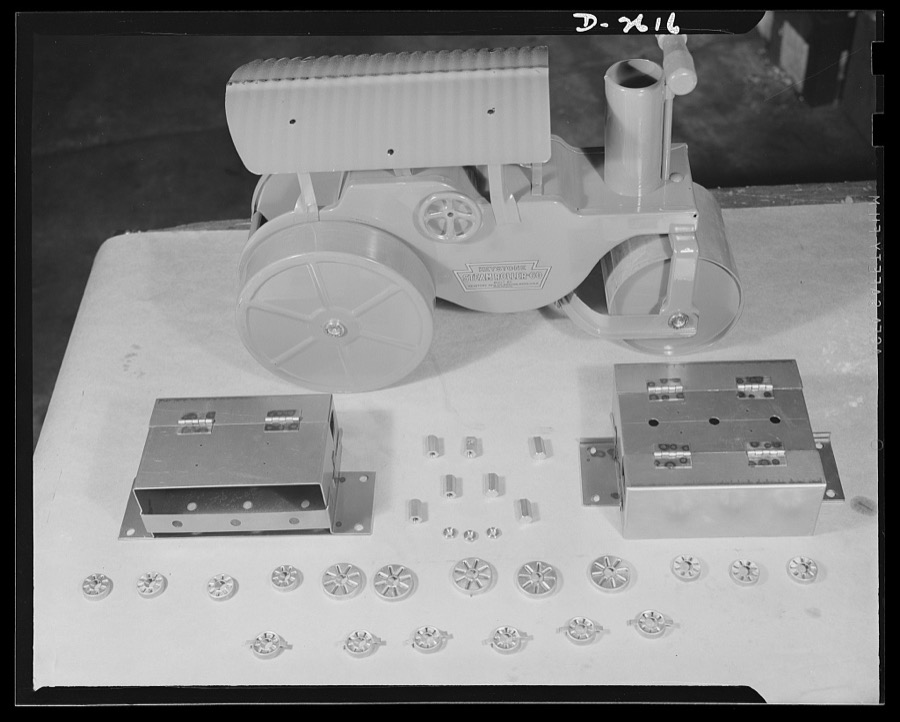 Conversion. Toy factory. Before and after conversion. Product of this New England factory before conversion was toys, such as this steam roller. Today, after converting its machinery, it is making radio filter boxes for tanks and jeeps. The small parts shown in the picture are used in the filter boxes