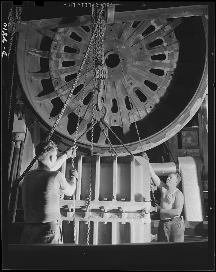 Conversion. Tire plant. This vulcanizing unit, largest in the world, was designed for the vulcanizing of giant tires used on earth-moving machinery; is now helping out the war program by vulcanizing self-sealing gas tanks for the nation's war planes. The mold containing the tank has been lowered into the vulcanizing unit and the huge cover is being lowered into position before the heat is turned on