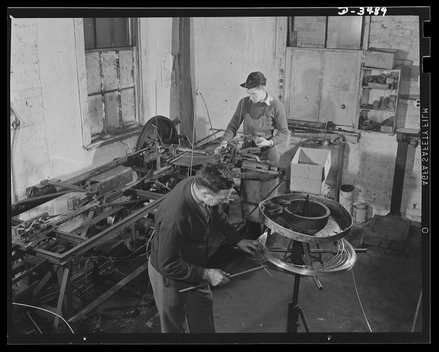 Conversion. Toy furniture to dies for incendiary bombs. This small Midwest machine shop used to manufacture doll's furniture and fly swatters before Pearl Harbor. Today, busy with subcontracts on war production orders, they're hurrying the last lengths of swatter-wire off the machines. Circular machines at right cuts and twists the lengths of wire. Sivon Machine Company, Painesville, Ohio