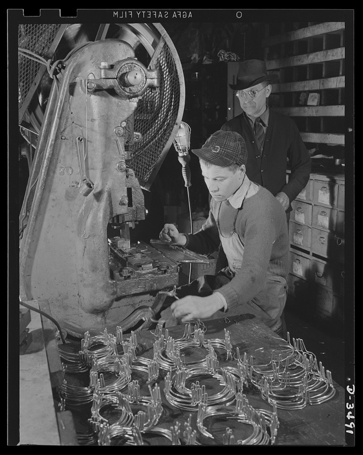 Conversion. Toy furniture to dies for incendiary bombs. This small Midwest machine shop used to manufacture doll's furniture and fly swatters before Pearl Harbor. Subcontracts on defense orders now occupy all machines as rapidly as the old stock can be assembled. Here two high school boys complete machine work on metal legs for the furniture. Sivon Machine Company, Painesville, Ohio