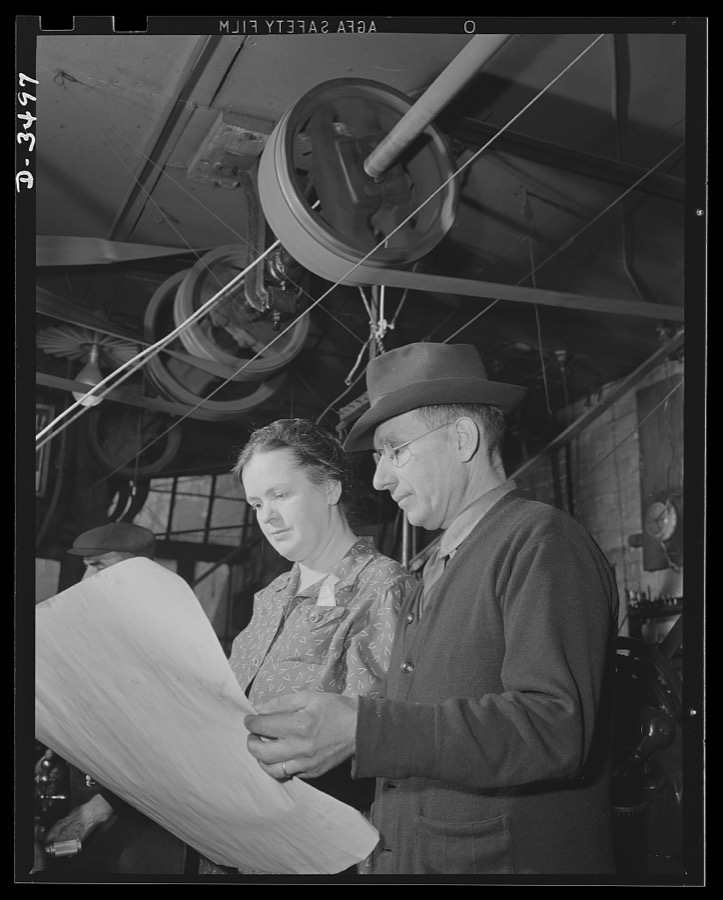 Conversion. Toy furniture to dies for incendiary bombs. More space for making bomb dies. The owner of a small factory and his wife inspect blue prints of the addition they need to accomodate their war production, on orders. Fifty, instead of seven men, will man the new shop. Sivon Machine Company, Painesville, Ohio