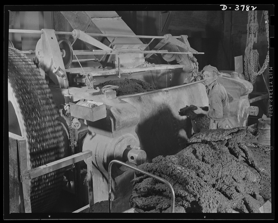 Rubber reclamation. Rubber harvest from scrapped tires. Reclaimed, dried scrap rubber is plasticized on the eighty-four-inch mill roll of a xylos process plant in the Midwest. Pigments are added to give the properties desired in the finished product. As it comes off the mill rolls, the reclaimed substance has regained the appearance of new rubber. Firestone