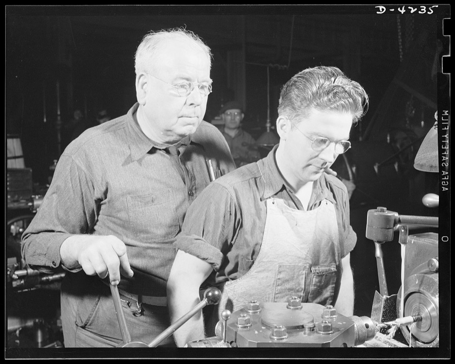Production. Diesel engines. Old hands and green hands back America's war production drive. An apprentice learning to operate a screw machine at a Midwest plant producing diesel engines for the Navy