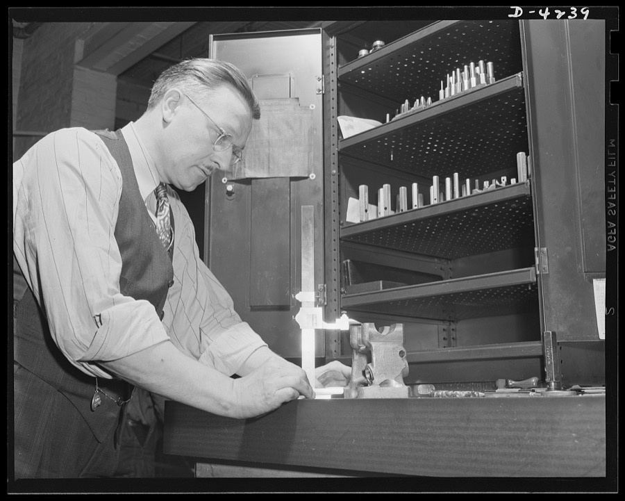 Production. Diesel engines. An inspector at a Midwest plant measures precision parts that will go into diesel engines being made for the Navy