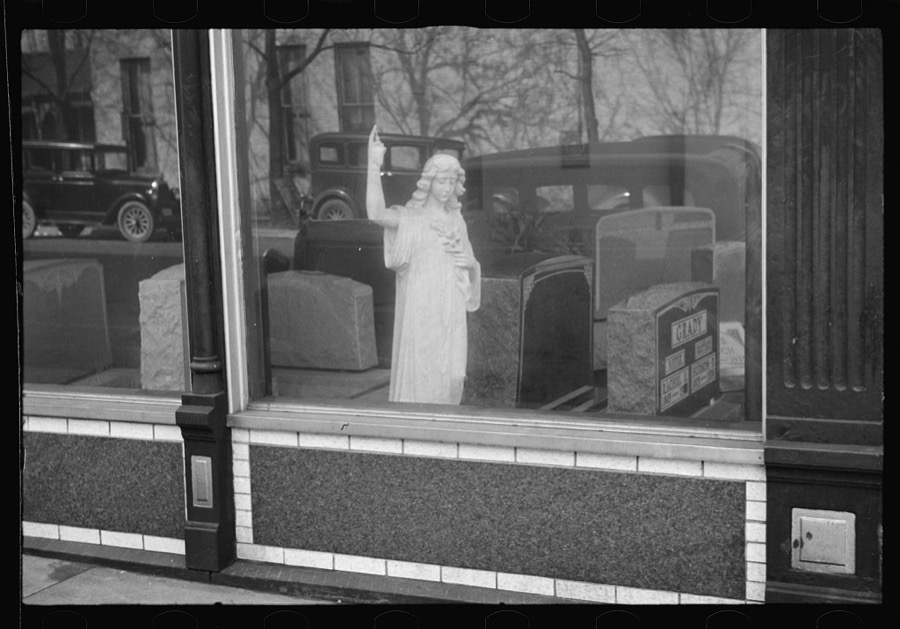 Gravestones and monument in dealer's window, Jackson, Ohio