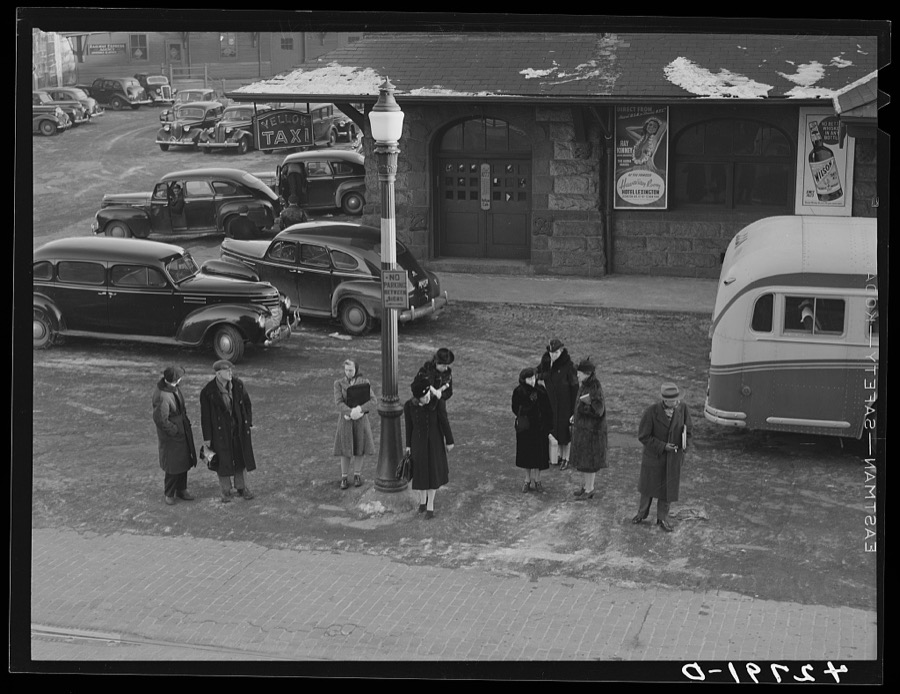 Commuters who have just gotten off the train waiting for the bus to go home. Lowell, Massachusetts