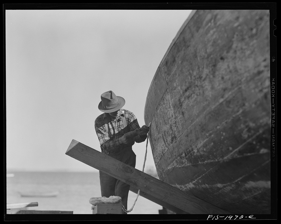 Provincetown, Massachusetts. Portuguese workmen building a cabin on an open dory