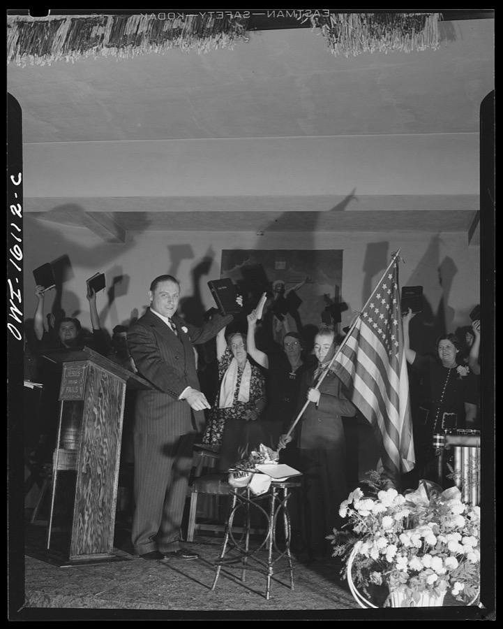 Toledo, Ohio. Evangelical church ceremony at which the preacher delivered a hysterical speech, and then burned a copy of Hitler's Mein Kampf. Preacher with the Bible, Mein Kampf burning, and a boy with the American flag