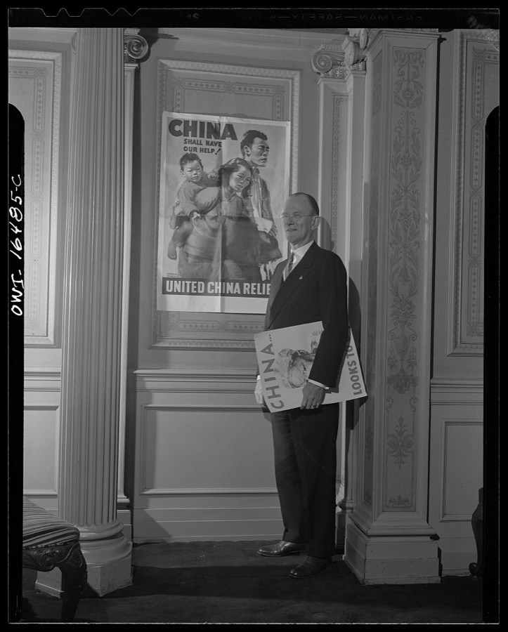 Toledo, Ohio. Ward Canaday, a millionaire, head of China Relief in Toledo, with a Chinese war relief poster