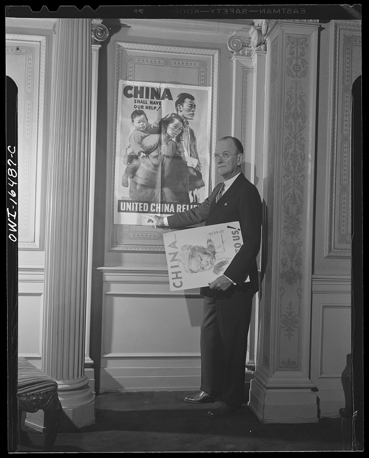 Toledo, Ohio. Ward Canaday, a millionaire, head of China Relief in Toledo, with a Chinese war relief poster