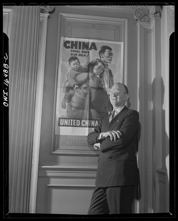 Toledo, Ohio. Ward Canaday, a millionaire, head of China Relief in Toledo, with a Chinese war relief poster