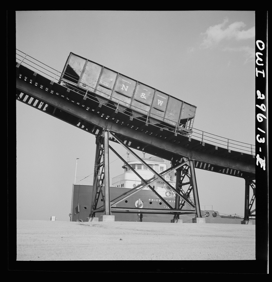 Sandusky, Ohio. Loading coal into a lake freighter at the Pennsylvania Railroad docks. The car that has just been emptied is going down the kick-back trestle