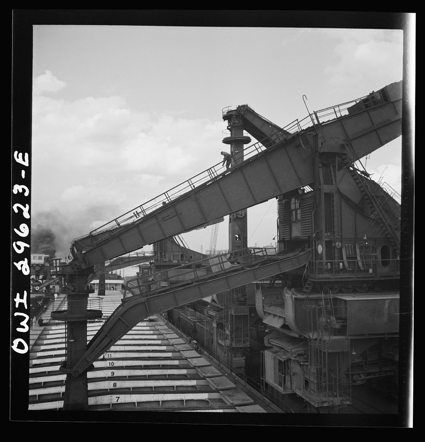 Cleveland, Ohio. Unloading iron ore from a lake freighter by means of Hewlett [i.e., Hulett] unloaders at the Pennsylvania Railroad docks