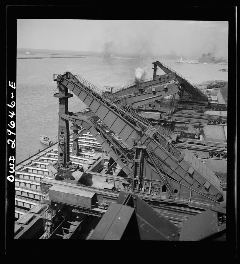 Cleveland, Ohio. Unloading iron ore from a lake freighter by means of Hewlett [i.e., Hulett] unloaders at the Pennsylvania Railroad docks