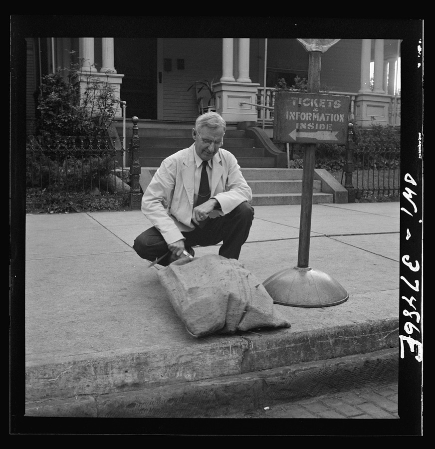 Washington Court House, Ohio. A ticket agent inspecting some freight left by bus