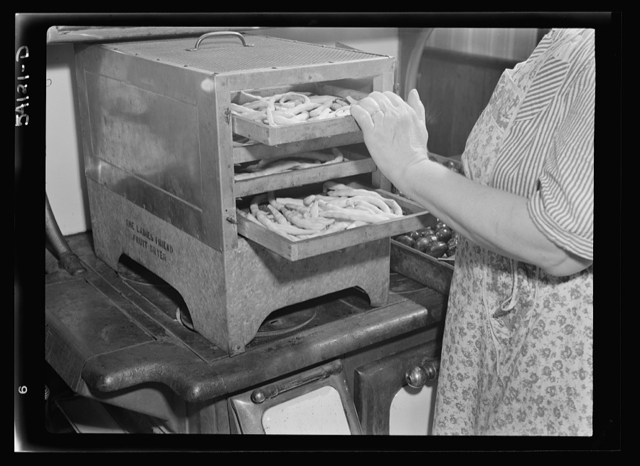 "The Ladies Friend" dryer, full of blanched pencil pod beans, on top of a coal and wood range