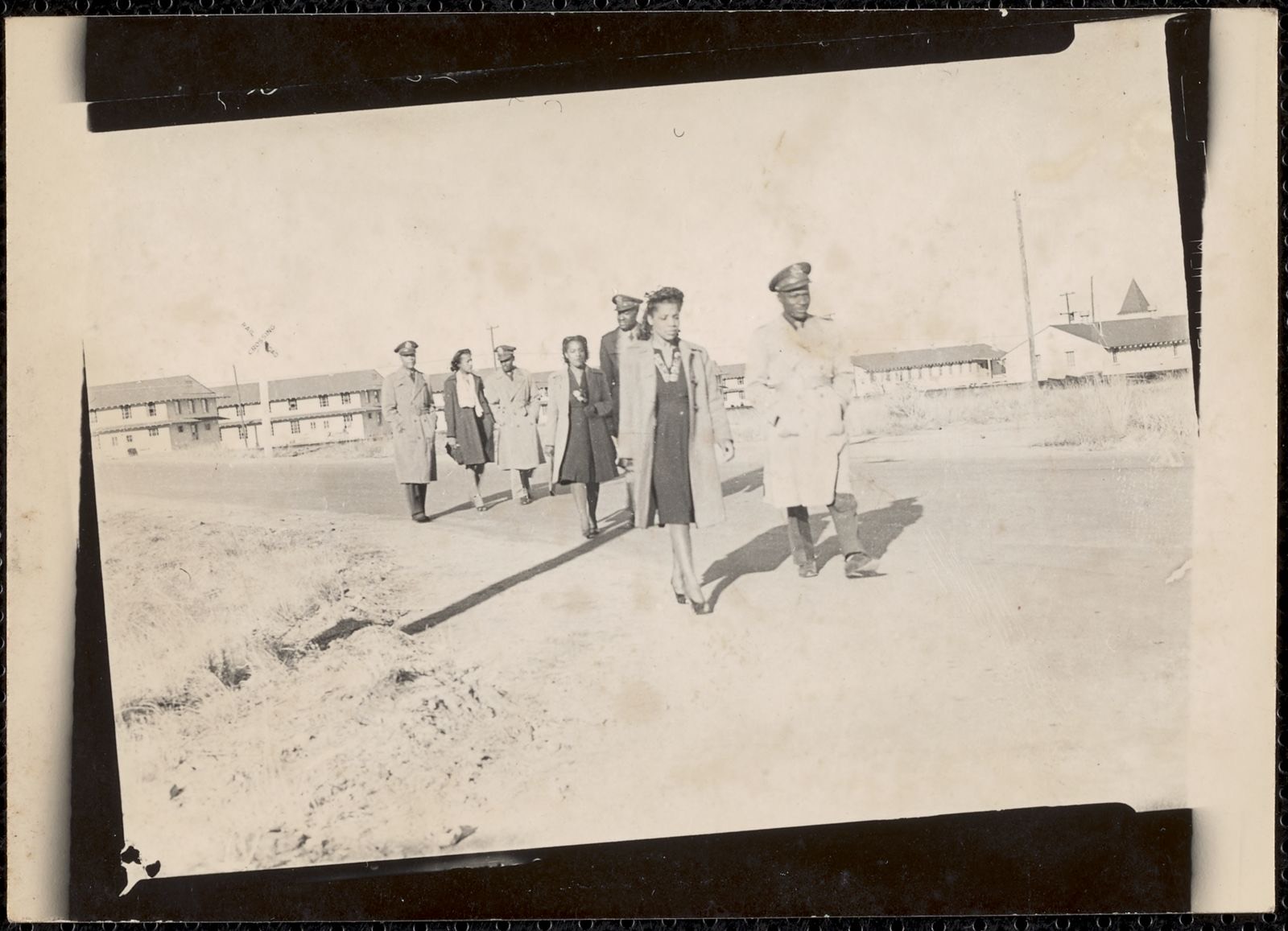 Four men and three women walk down the road, Boston Public Library - undated