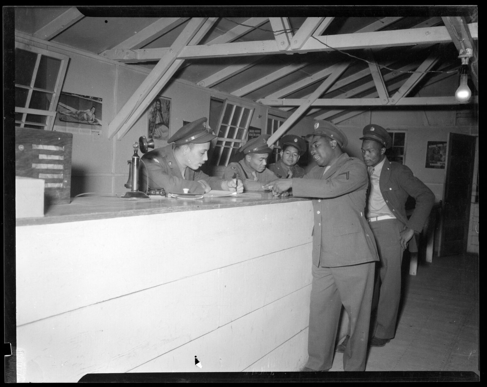 Soldiers at counter with telephone and paperwork, Boston Public Library - undated