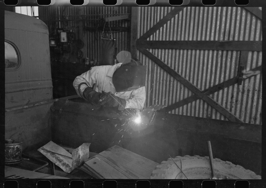 The United Producers and Consumers Cooperative maintains an automobile repair shop. In this picture, a worker is repairing a farmer's truck with an electric welder. Phoenix, Arizona