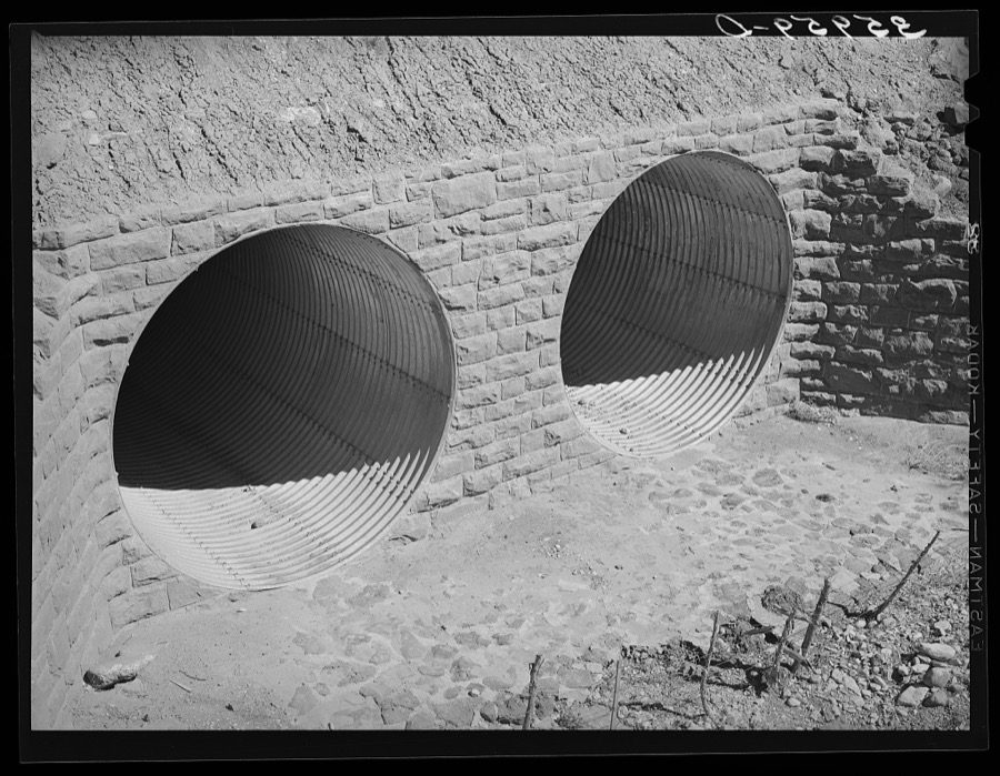 Conduits under the highway to carry off flood waters, thus protecting the highway. U.S. 60, Navajo County, Arizona