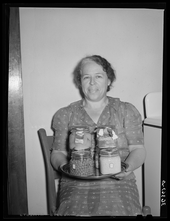 Wife of member of the Casa Grande Valley Farms, displaying canned goods with which she won prizes at the state fair. Pinal County, Arizona